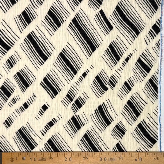 Tissu polyester gaufré rayures abstraites noires sur fond crème