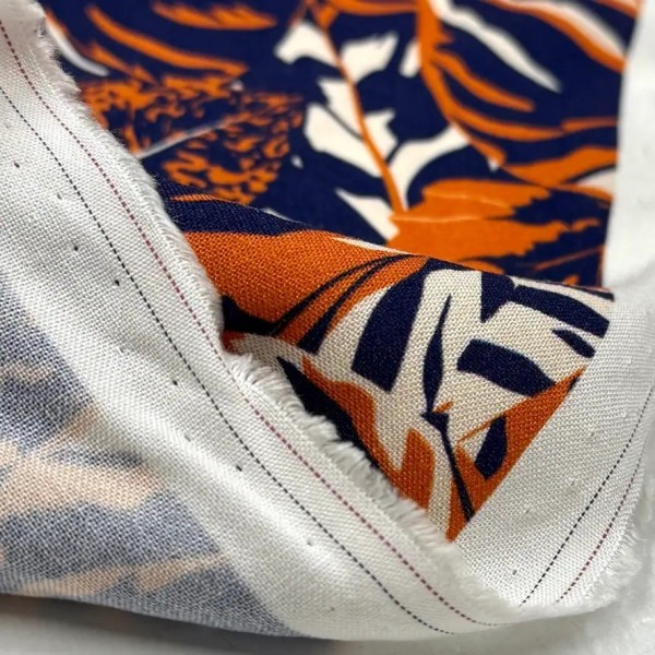 Tissu viscose feuillage orange sur fond bleu marine foncé Tissu viscose feuillage orange sur fond bleu marine foncé