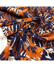 Tissu viscose feuillage orange sur fond bleu marine foncé