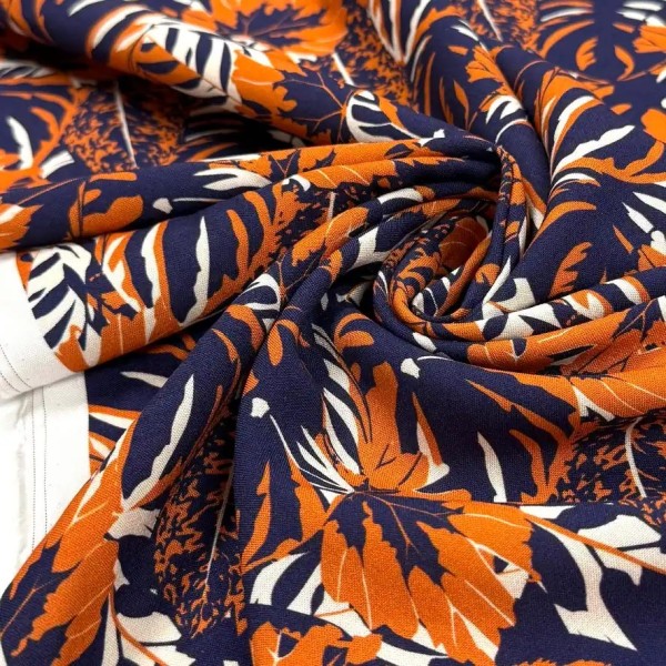Tissu viscose feuillage orange sur fond bleu marine foncé Tissu viscose feuillage orange sur fond bleu marine foncé