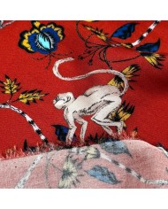 Tissu viscose singes et fleurs exotiques sur fond rouge