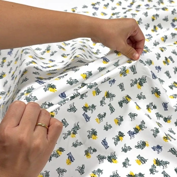 Tissu coton élasthanne tigres et feuillage sur fond blanc