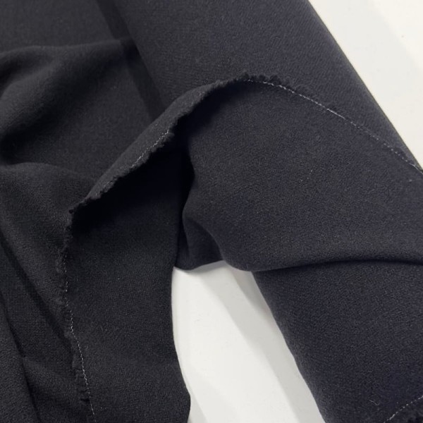 Tissu laine polyester aspect crêpe uni noir Tissu laine polyester aspect crêpe uni noir