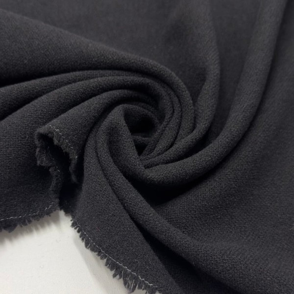 Tissu laine polyester aspect crêpe uni noir Tissu laine polyester aspect crêpe uni noir