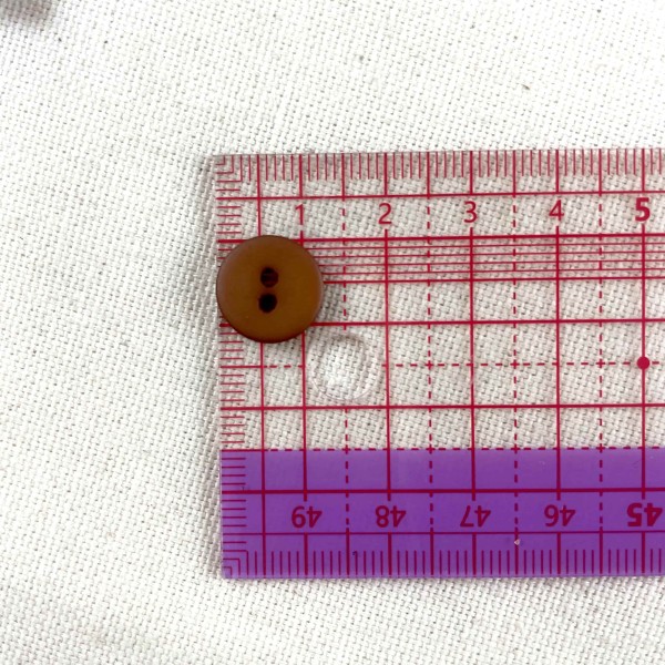 Bouton rond plastique marron 12mm Bouton rond plastique marron 12mm