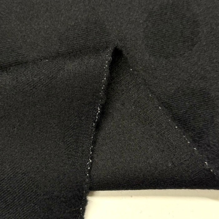 Tissu laine polyester à pois noirs sur fond noir Tissu laine polyester à pois noirs sur fond noir